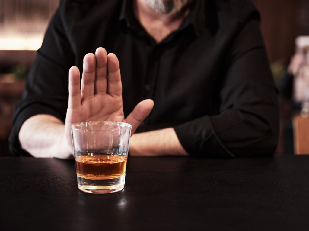Man refuses or rejects to drink alcohol at the pub