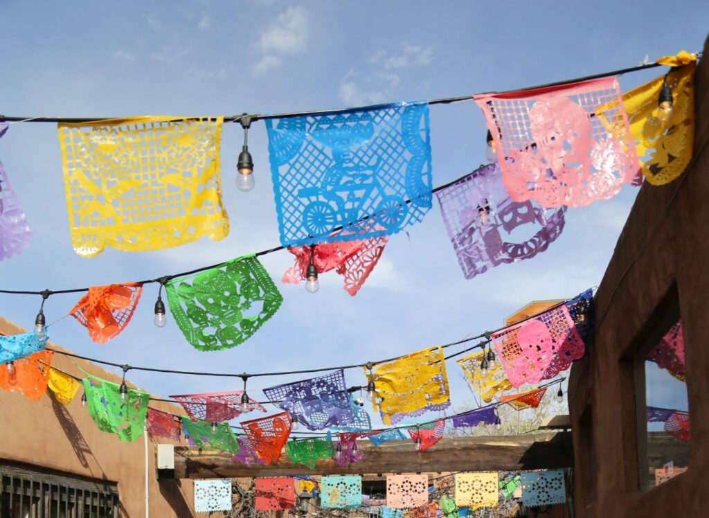Colorful papel picados banners decorate a street in Old Town Albuquerque